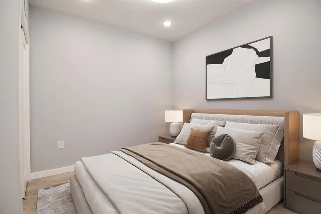 a bedroom with a bed and wall painting