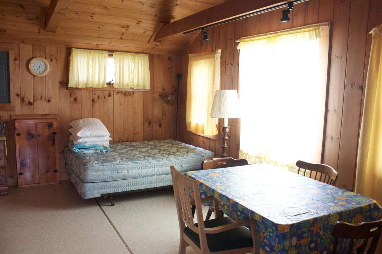 242 Shore Road Truro, MA 02666 - Photo 16 of 25 a bedroom with a bed and a table