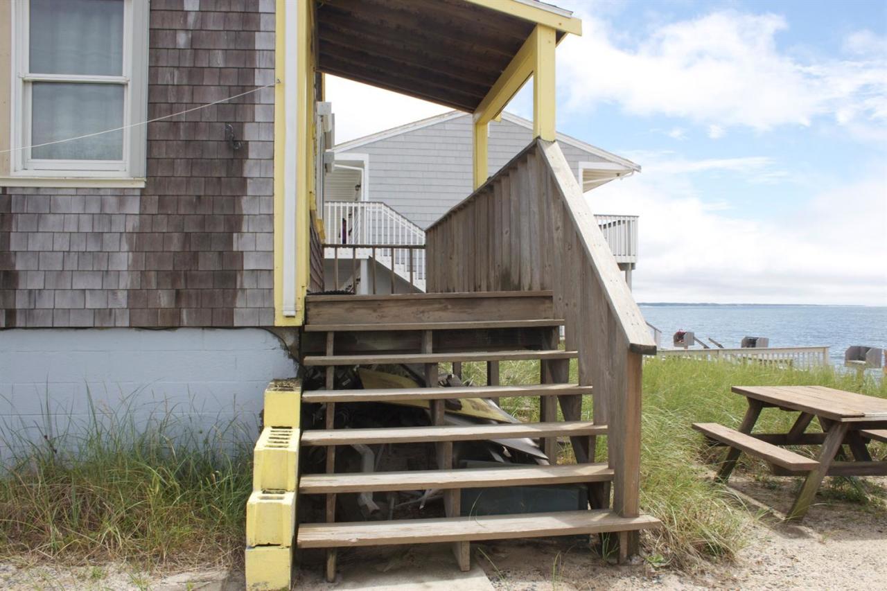 242 Shore Road Truro, MA 02666 - Photo 4 of 25 a front view of a house with a yard
