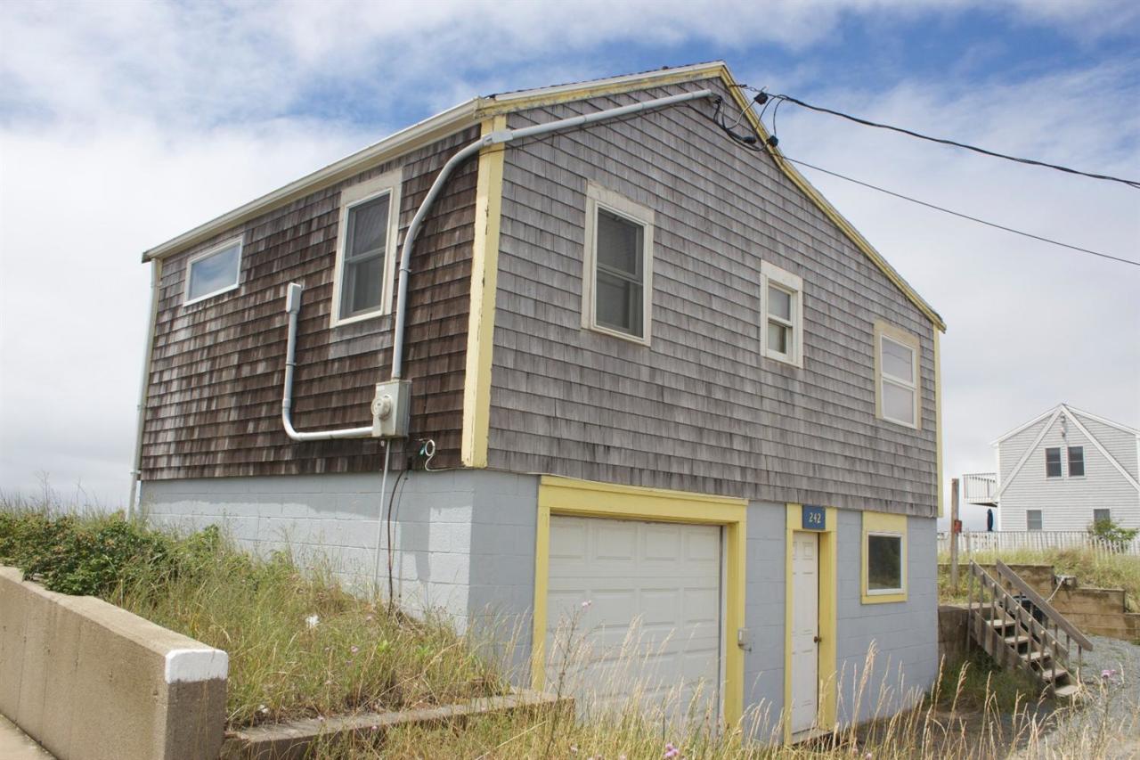 242 Shore Road Truro, MA 02666 - Photo 8 of 25 a front view of a house with a yard