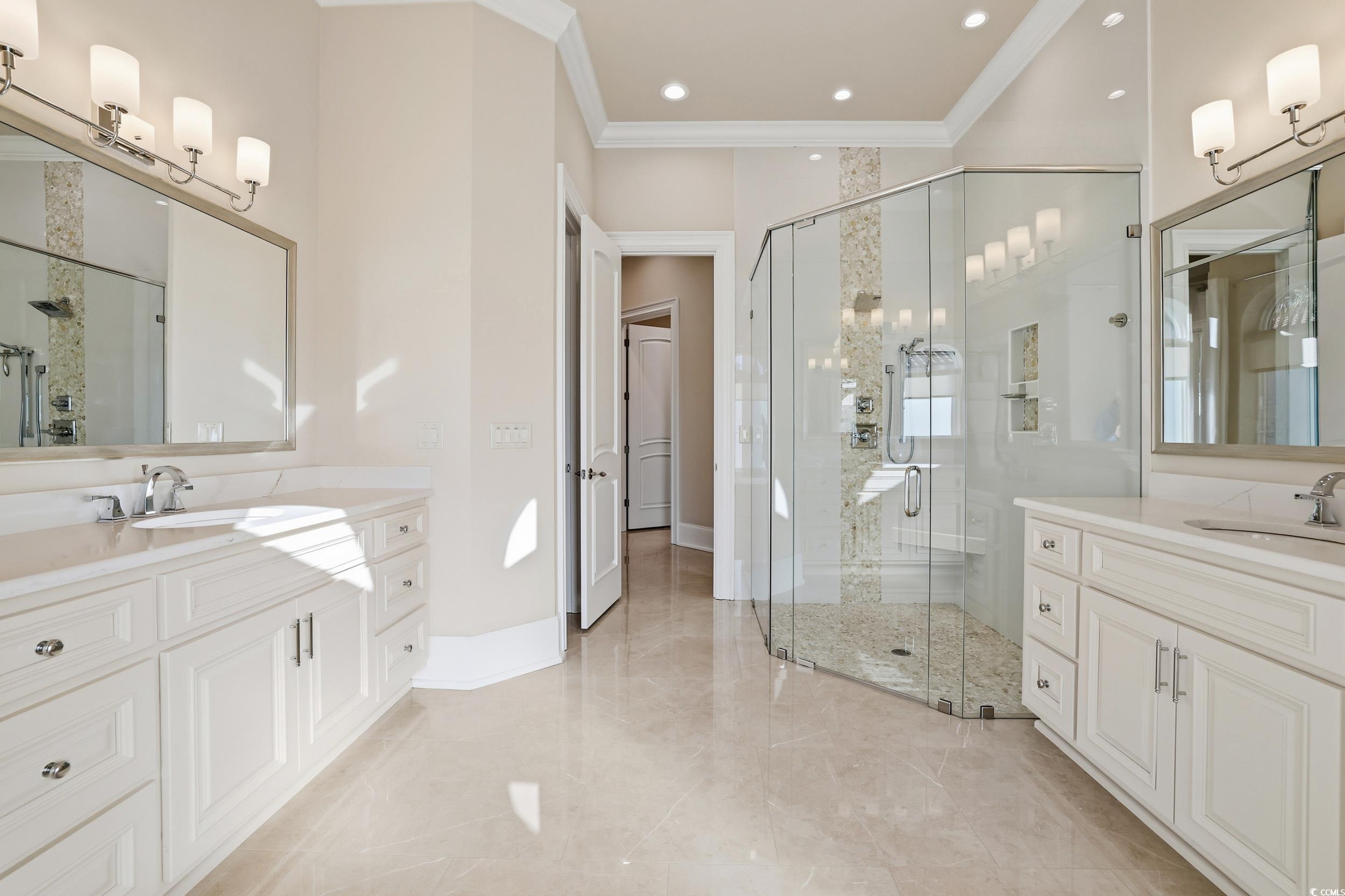 345 Posada Drive Myrtle Beach, SC 29572 - Photo 11 of 40 Bathroom with two vanities, a shower stall, and crown molding