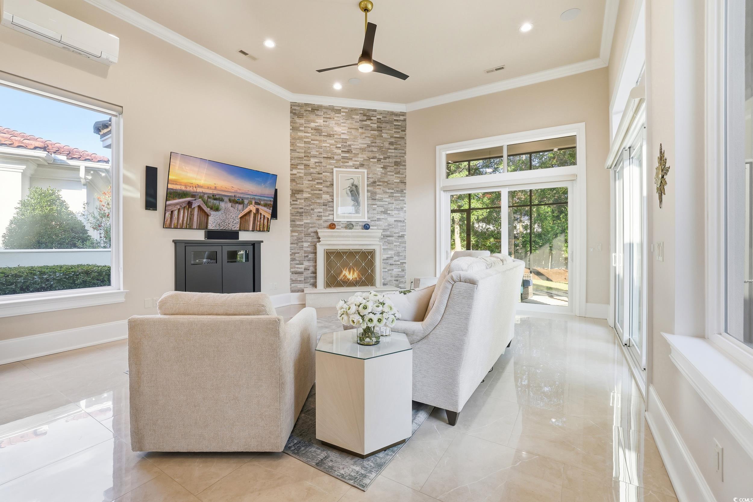 345 Posada Drive Myrtle Beach, SC 29572 - Photo 16 of 39 Family Room featuring a fireplace, ornamental molding, ceiling fan, and recessed lighting