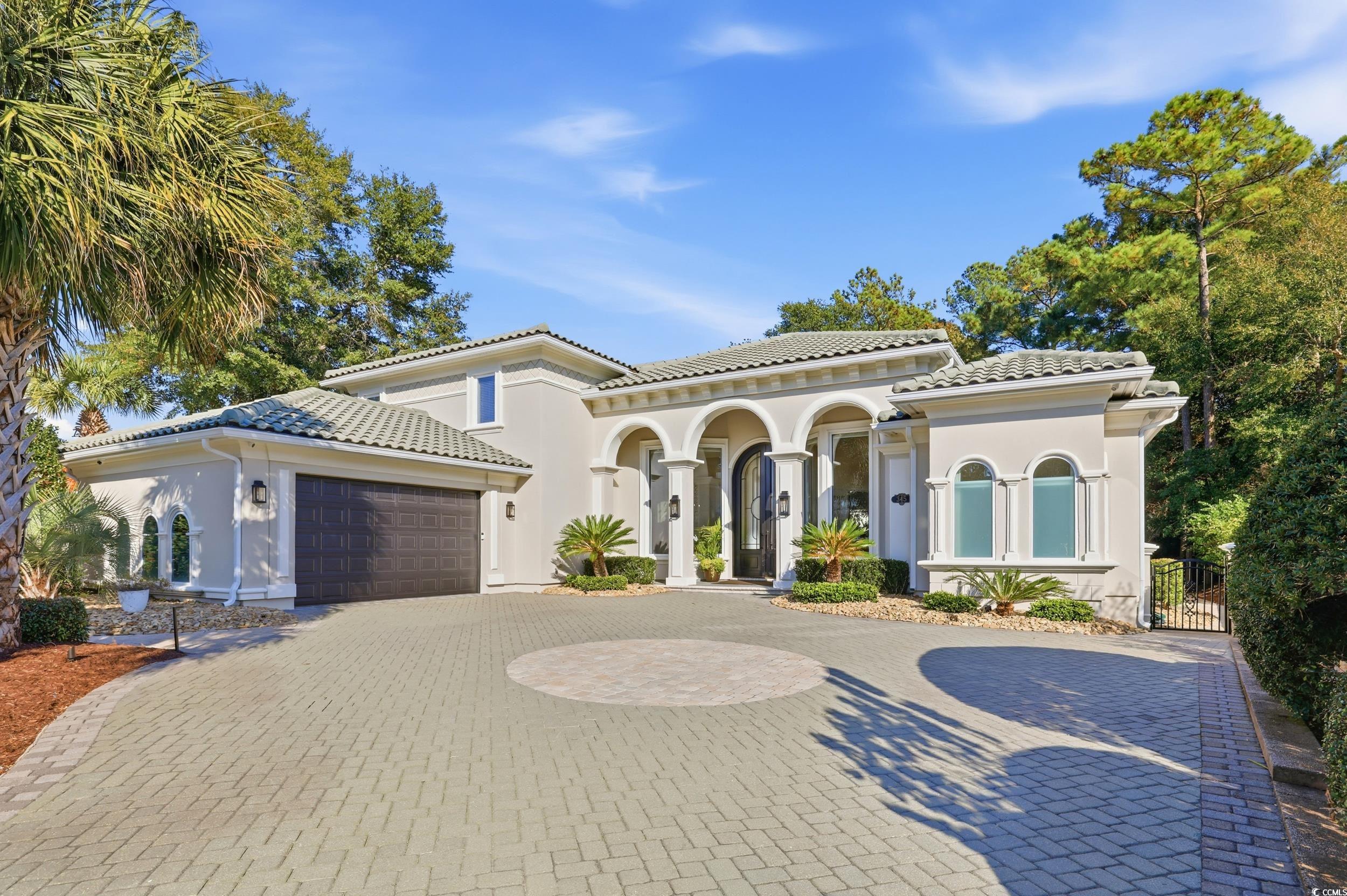 345 Posada Drive Myrtle Beach, SC 29572 - Photo 2 of 39 Mediterranean / spanish-style house featuring an attached garage, stucco siding, decorative driveway, a tiled roof