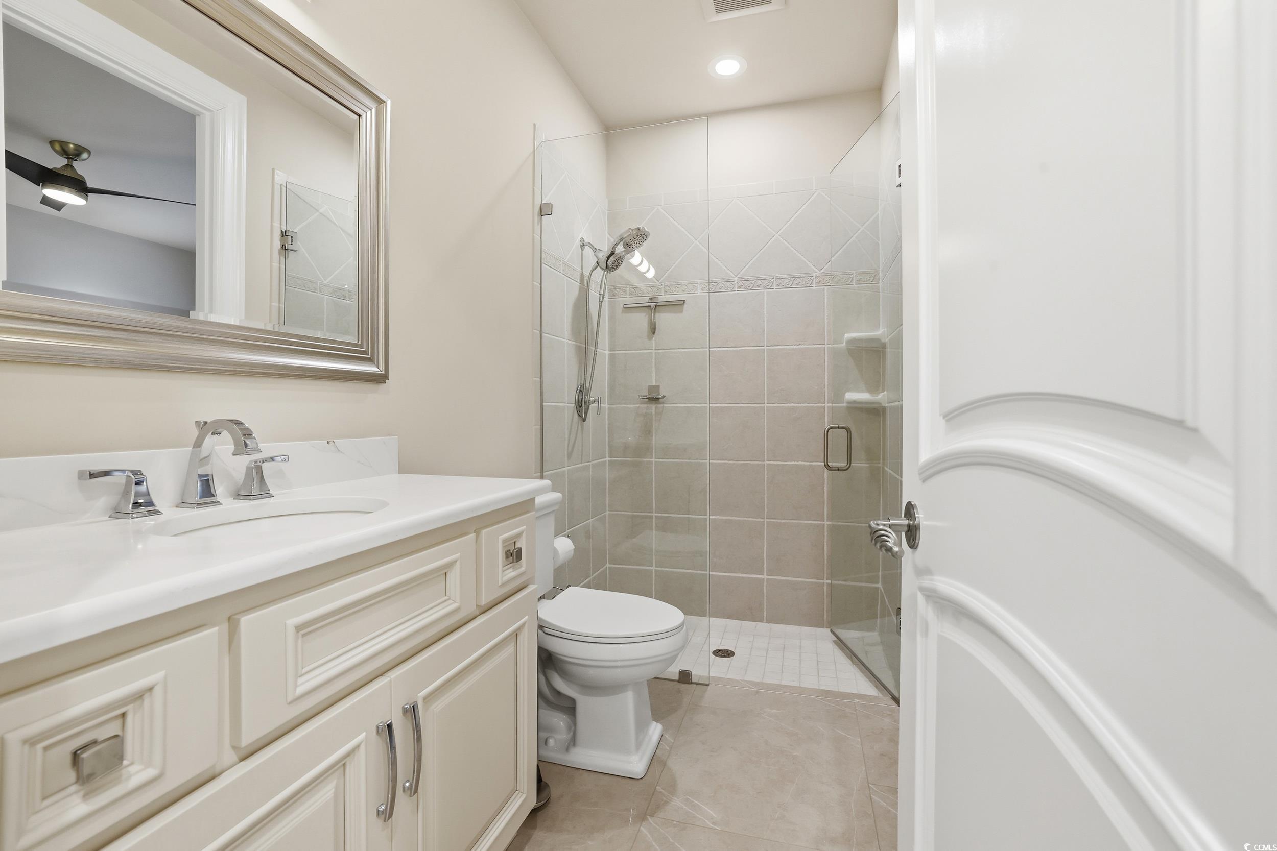 345 Posada Drive Myrtle Beach, SC 29572 - Photo 24 of 39 Full bathroom featuring vanity, a stall shower, and light tile patterned floors