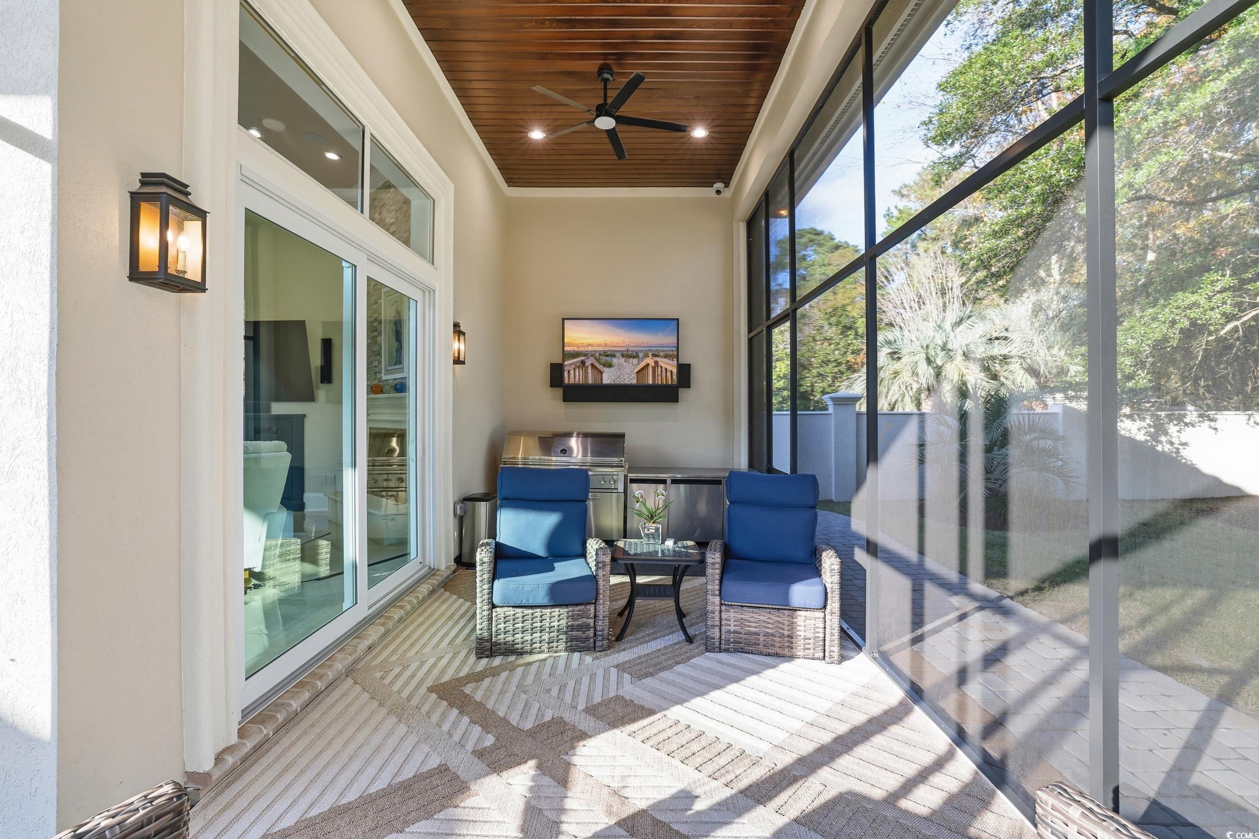 345 Posada Drive Myrtle Beach, SC 29572 - Photo 25 of 39 Screened Porch off of the Family Room featuring a ceiling fan and an outdoor living space
