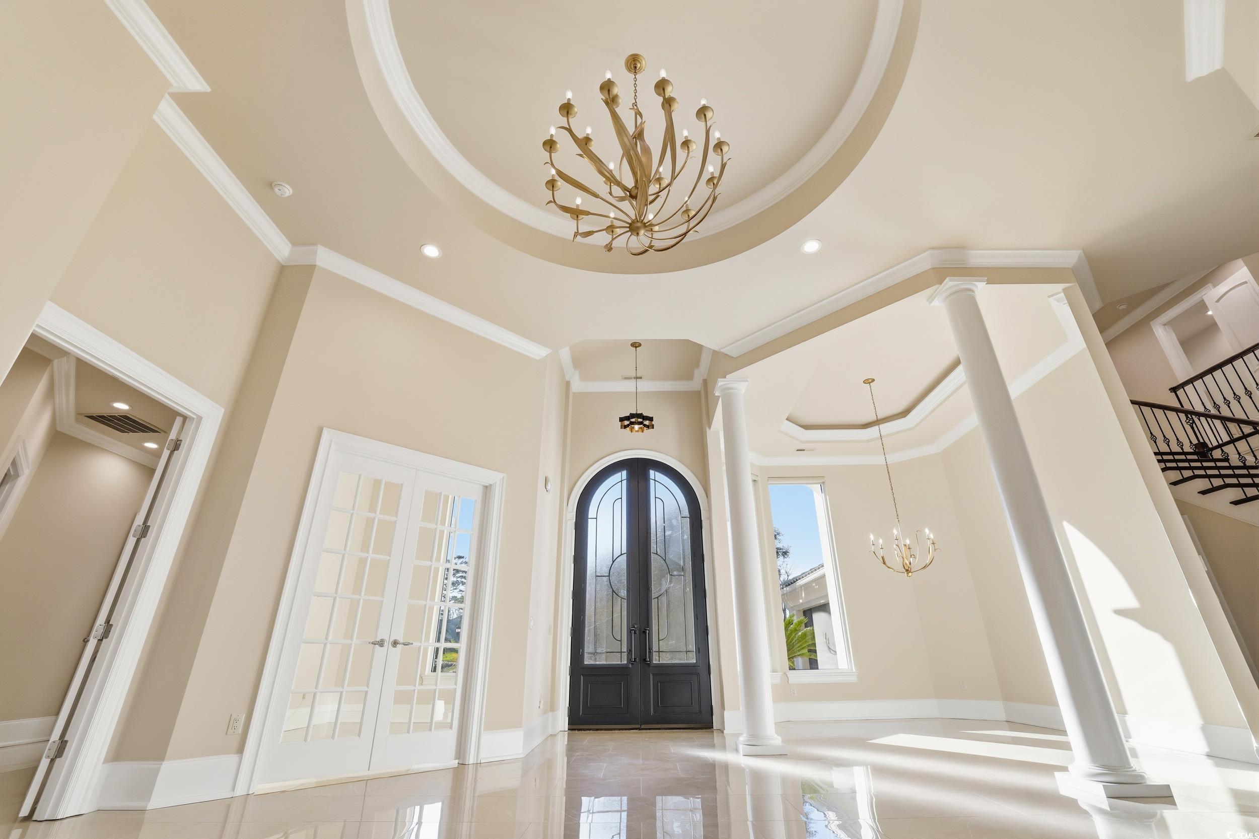 345 Posada Drive Myrtle Beach, SC 29572 - Photo 4 of 40 Foyer entrance with a chandelier, french doors, a raised ceiling, ornamental molding, and a towering ceiling