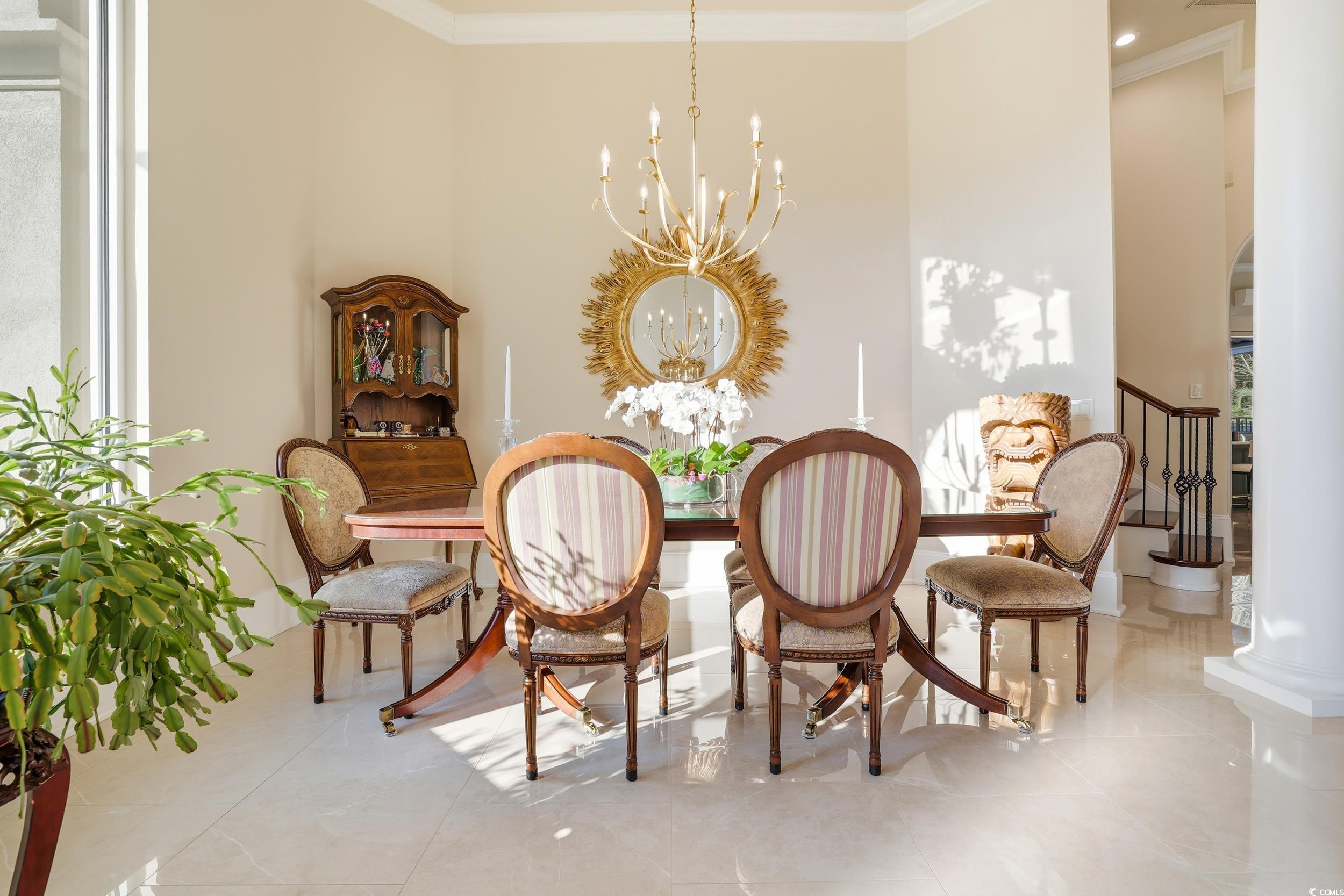 345 Posada Drive Myrtle Beach, SC 29572 - Photo 6 of 39 Dining room with a chandelier, ornamental molding, and tile patterned flooring