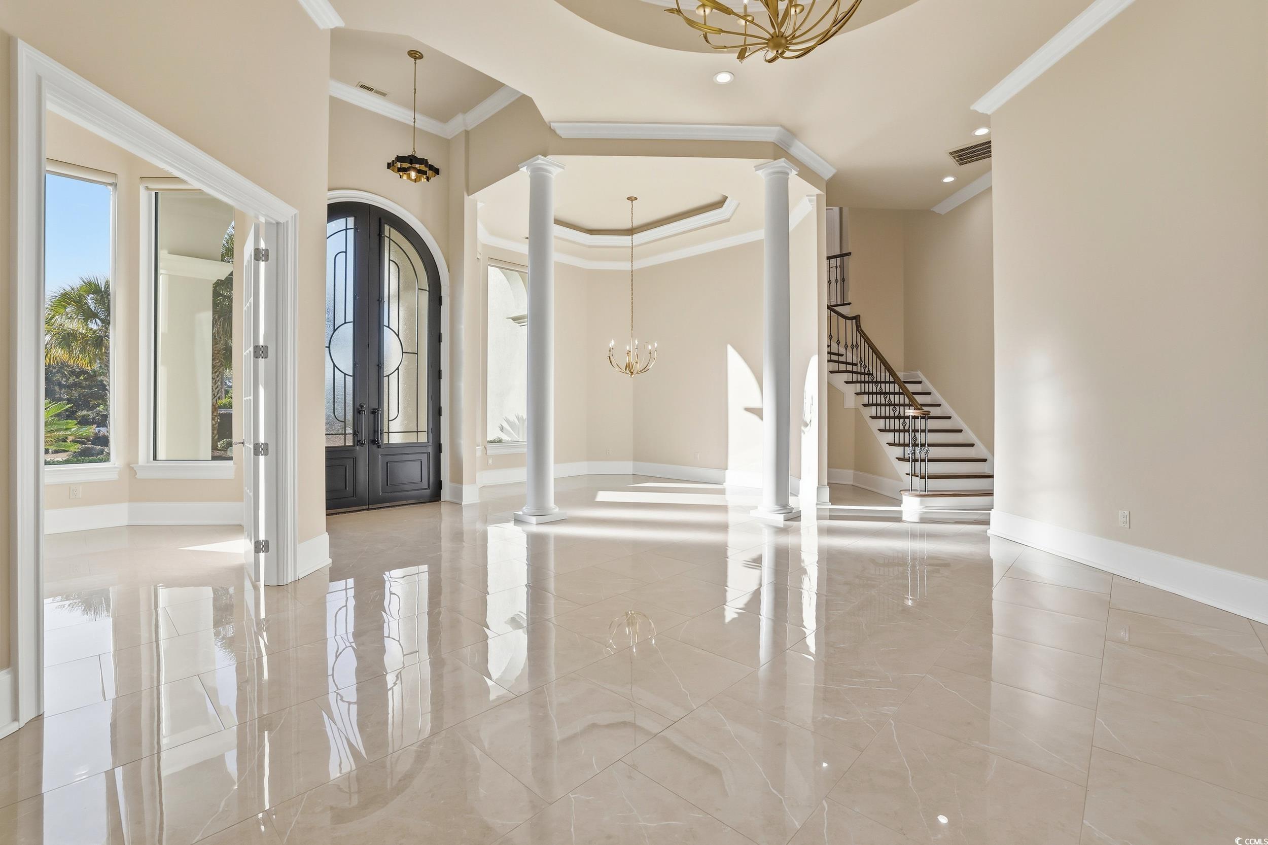 345 Posada Drive Myrtle Beach, SC 29572 - Photo 6 of 40 Entrance foyer with a chandelier, french doors, ornamental molding, and decorative columns