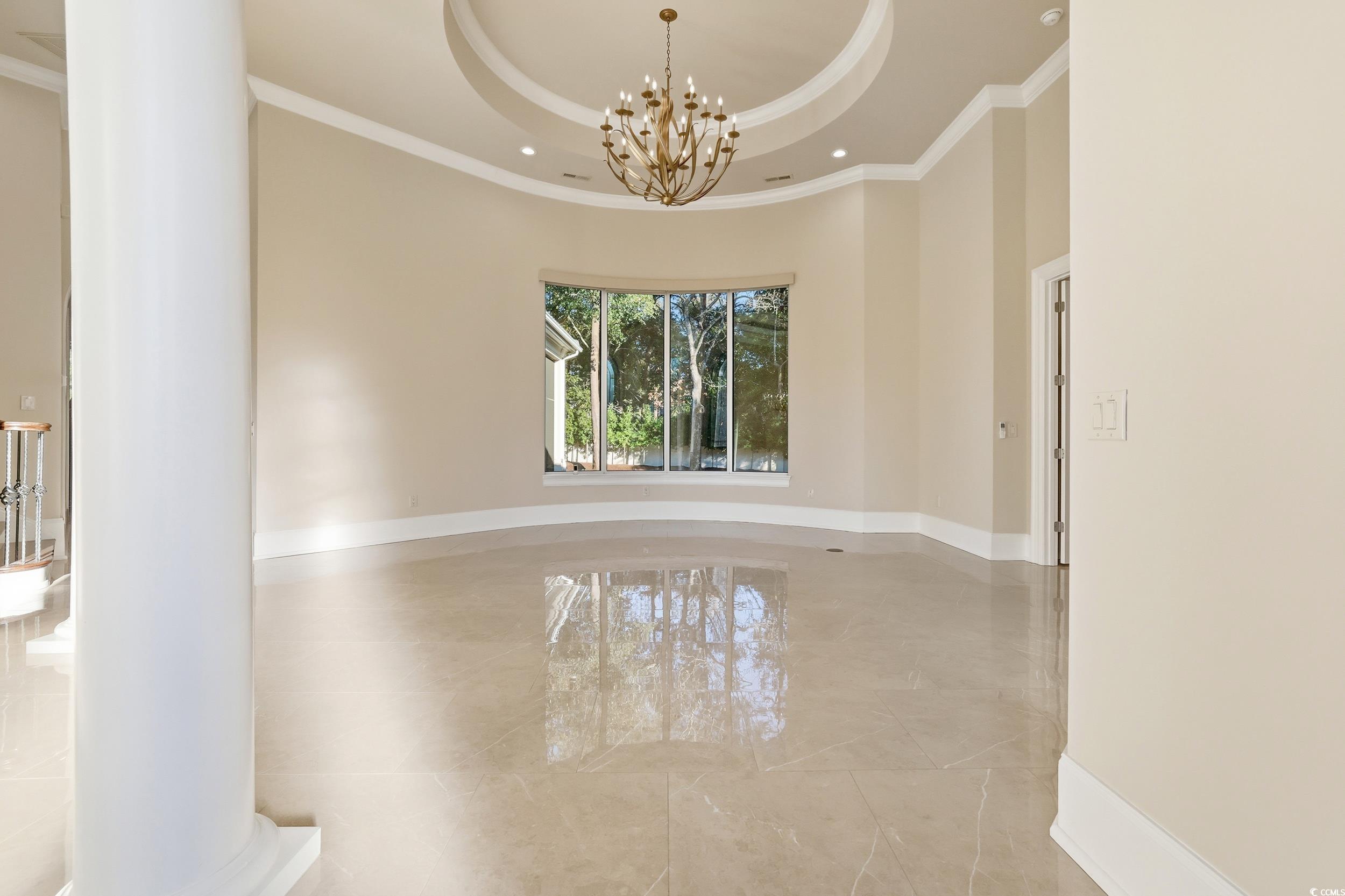 345 Posada Drive Myrtle Beach, SC 29572 - Photo 7 of 40 Unfurnished room with a tray ceiling, a chandelier, marble tiled floors, crown molding, and recessed lighting
