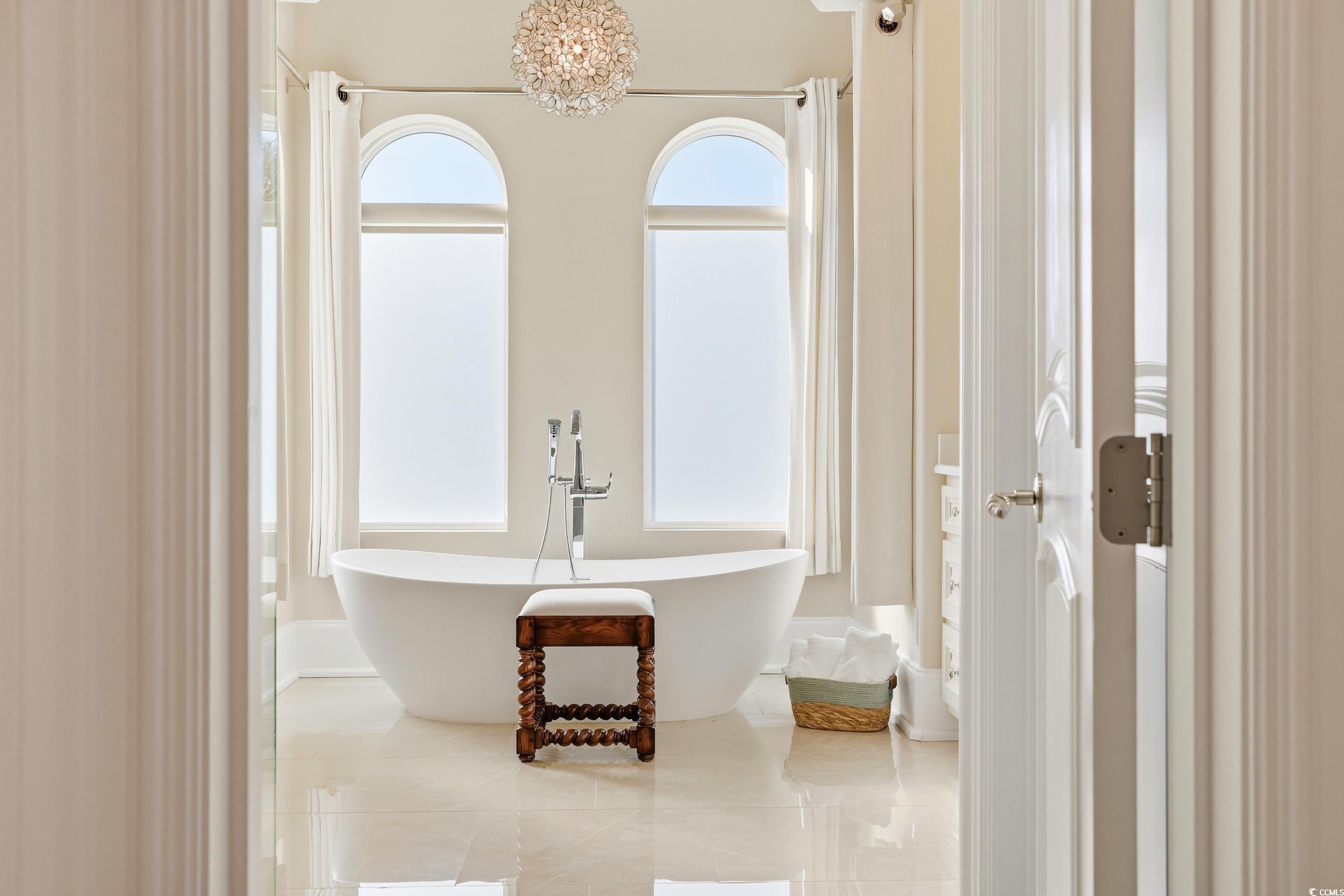 345 Posada Drive Myrtle Beach, SC 29572 - Photo 10 of 39 Primary Bathroom with a freestanding bath, a large shower, and healthy amount of natural light