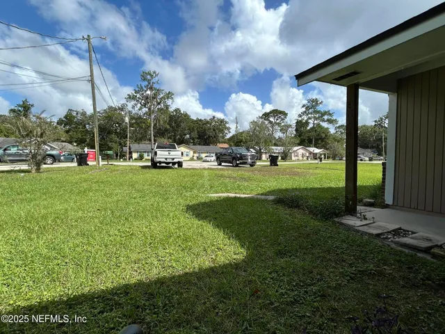 a view of a park with large trees