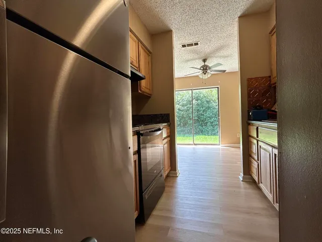 a hallway with wooden floor windows and entryway