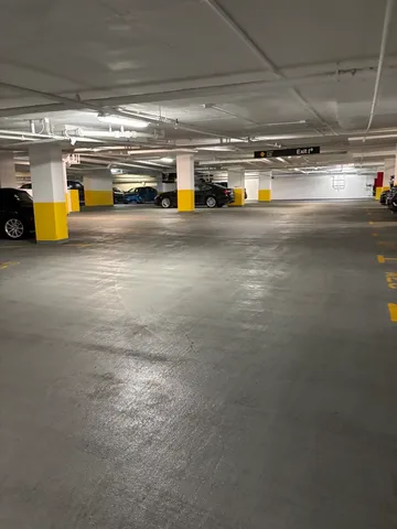 a view of parking garage with cars
