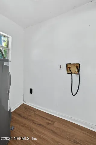 a view of a room with wooden floor and a glass door