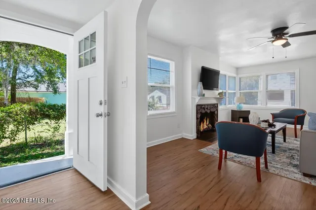 a living room with furniture a fireplace and a flat screen tv