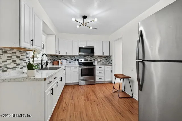 a kitchen with stainless steel appliances a refrigerator stove microwave and cabinets