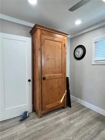 an empty room with wooden floor and window