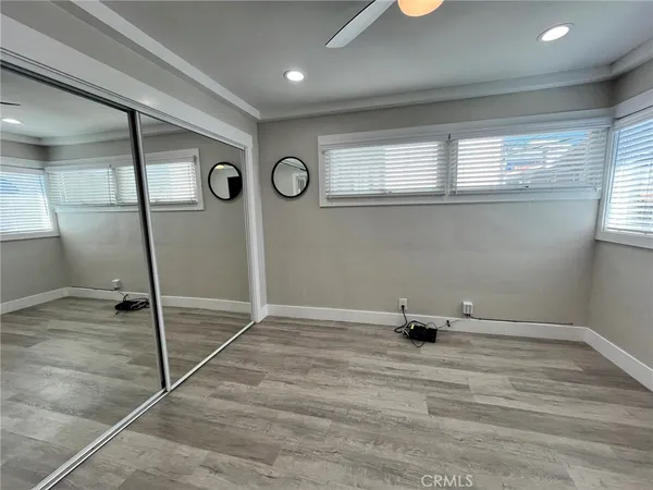 a room with a wooden floor and white walls