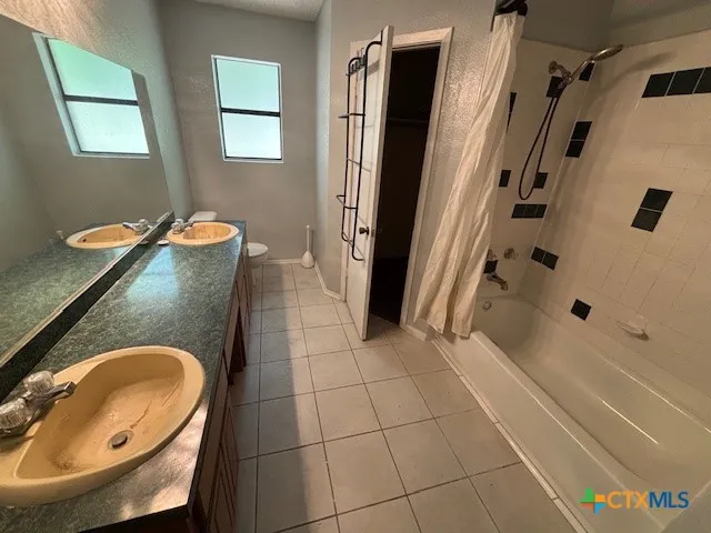 a bathroom with a tub a sink and a shower