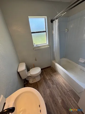 a bathroom with a sink mirror vanity and toilet