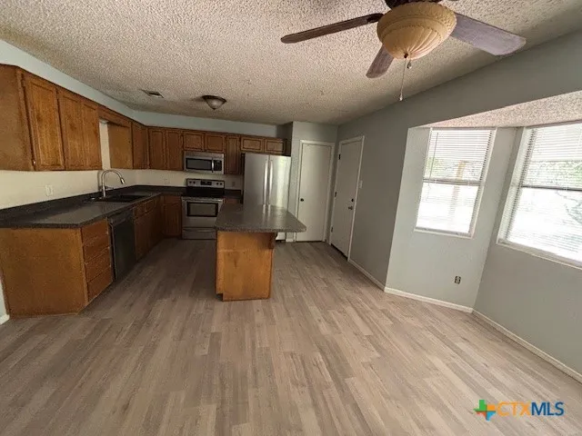 a kitchen with granite countertop a stove top oven and sink