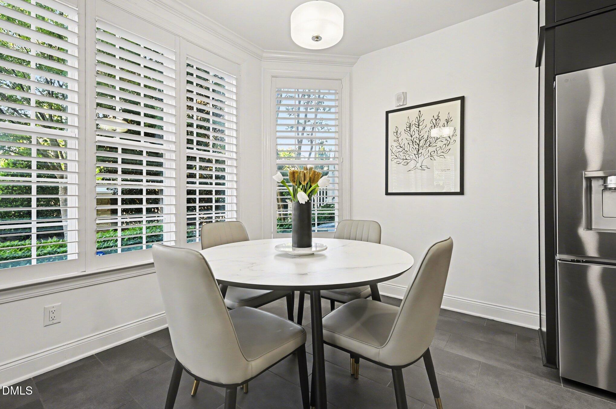 10420 Sablewood Drive, Unit 112 Raleigh, NC 27617 - Photo 11 of 31 a view of a dining room with furniture and a window