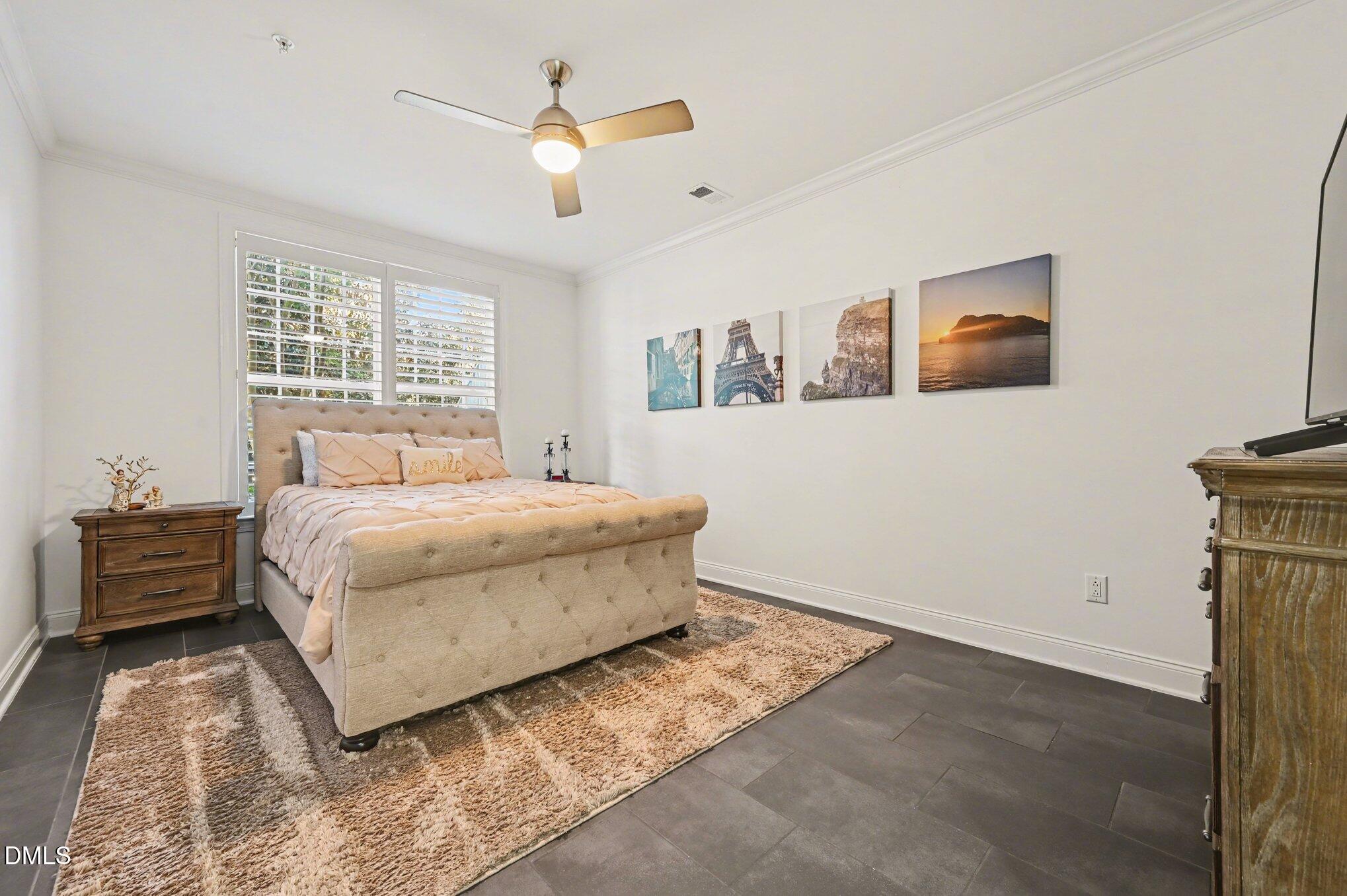 10420 Sablewood Drive, Unit 112 Raleigh, NC 27617 - Photo 14 of 31 a bedroom with a bed and a painting on the wall