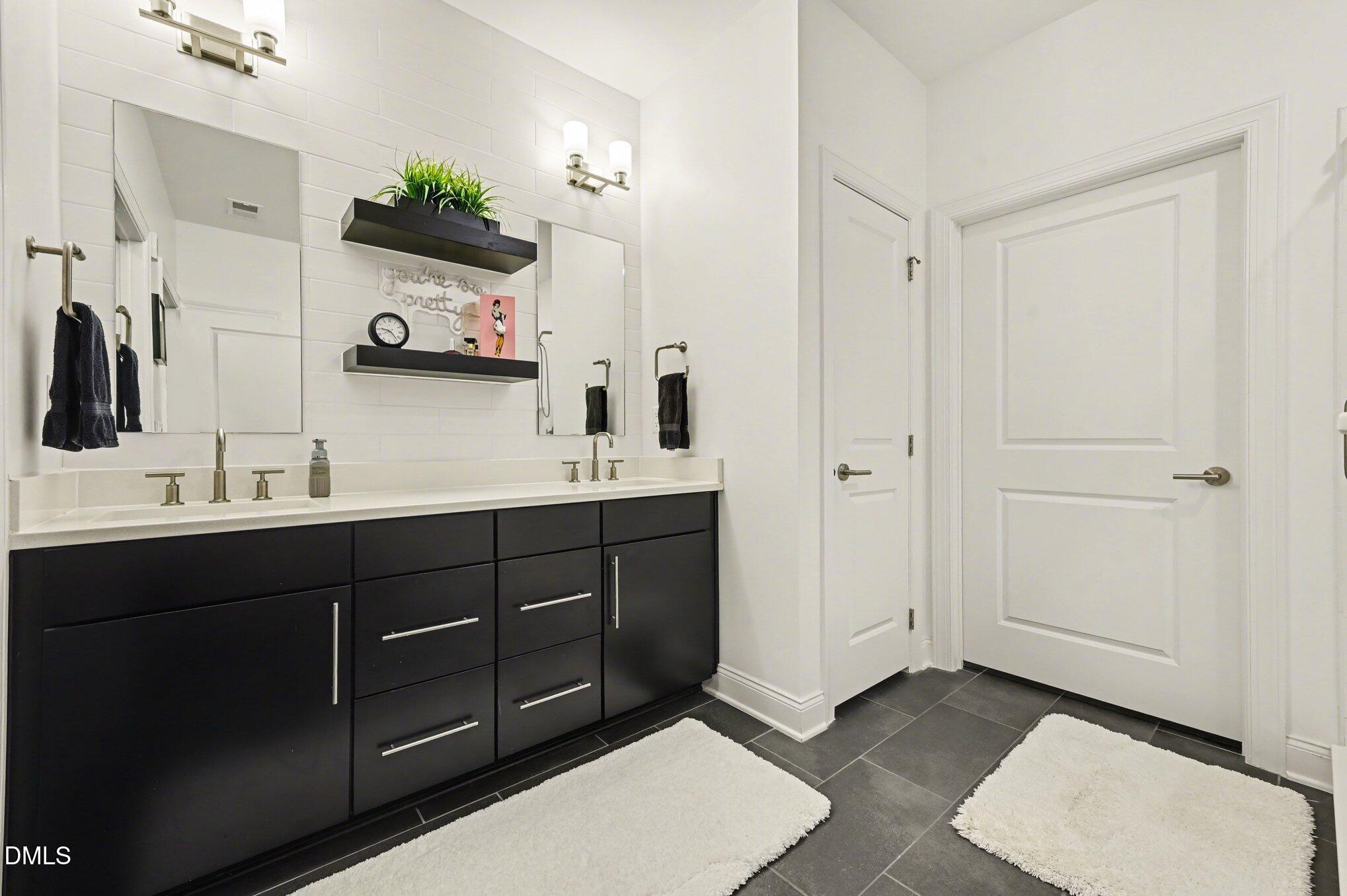 10420 Sablewood Drive, Unit 112 Raleigh, NC 27617 - Photo 16 of 31 a spacious bathroom with double vanity and a mirror
