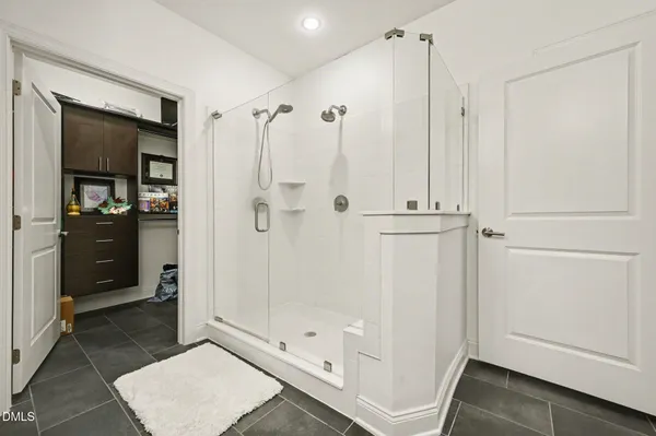 a bathroom with a glass shower door