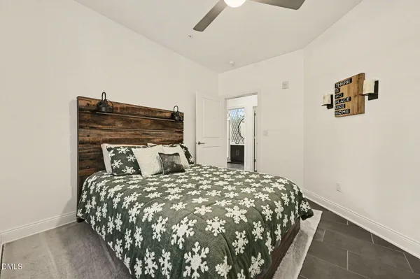 a bedroom with a bed and painting on the wall