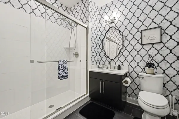 a bathroom with a toilet and a shower