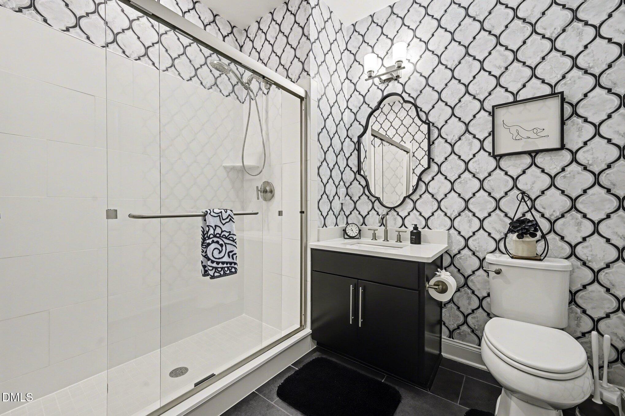10420 Sablewood Drive, Unit 112 Raleigh, NC 27617 - Photo 21 of 31 a bathroom with a toilet and a shower