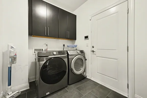 a utility room with sink dryer and washer