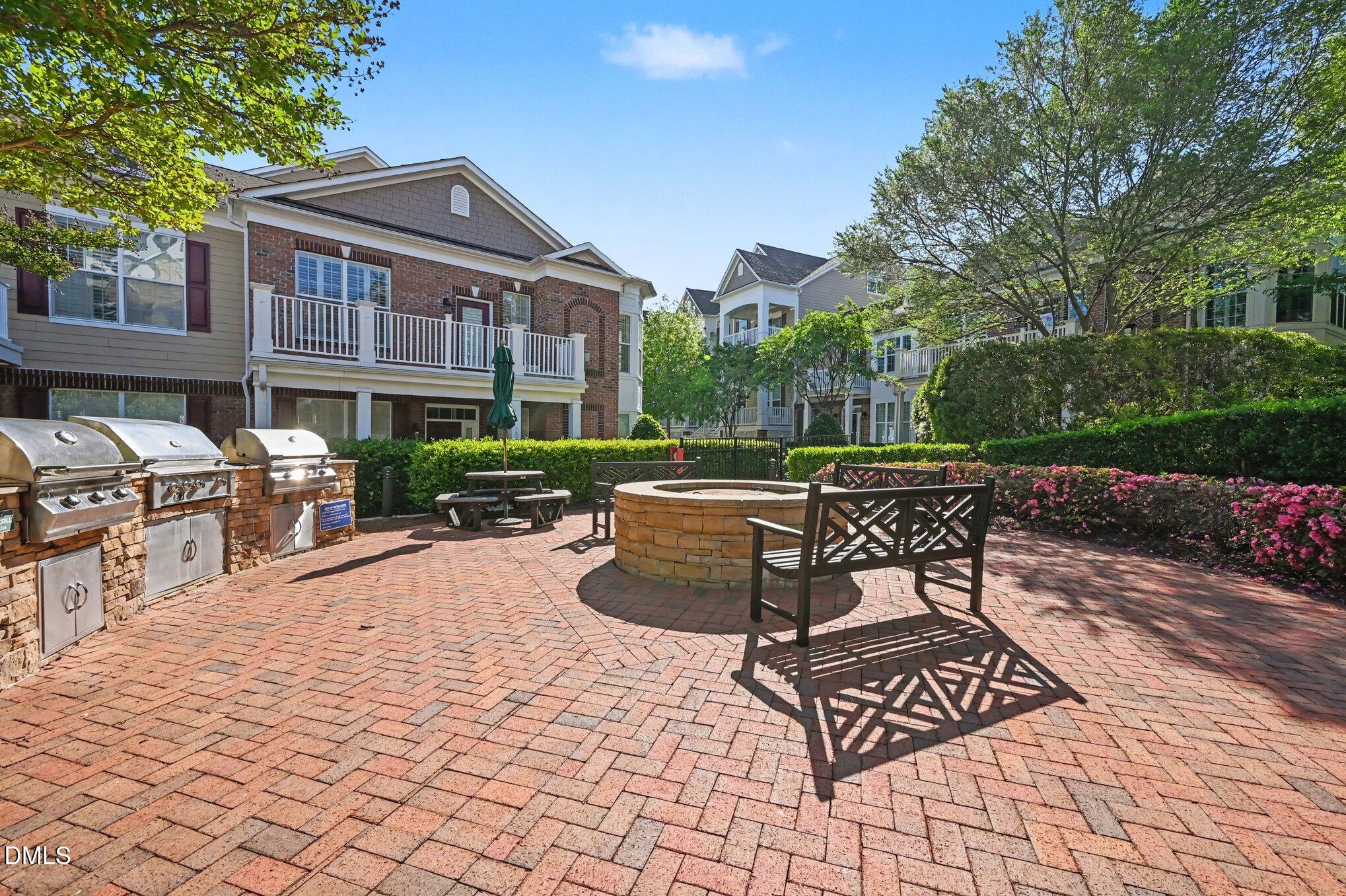 10420 Sablewood Drive, Unit 112 Raleigh, NC 27617 - Photo 26 of 31 a view of a patio with table and chairs and potted plants