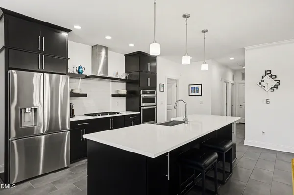 a kitchen with a refrigerator a sink and kitchen island