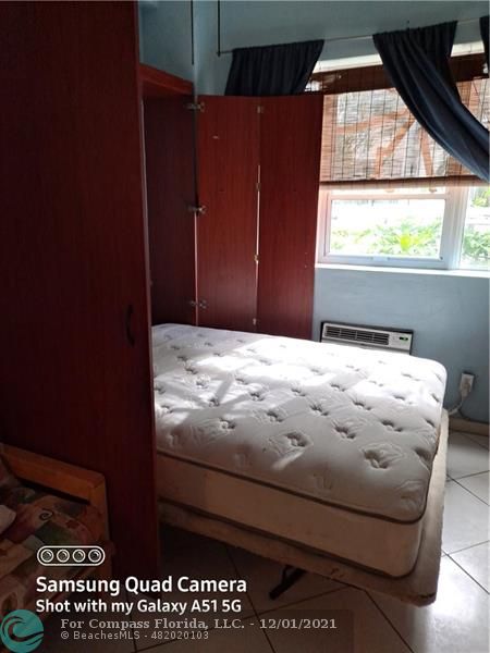 255 West 24th Street, Unit 105 Miami Beach, FL 33140 - Photo 22 of 47 a bedroom with a bed and a window