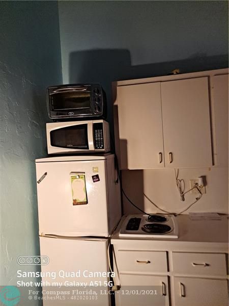 255 West 24th Street, Unit 105 Miami Beach, FL 33140 - Photo 24 of 47 a stove top oven sitting inside of a kitchen