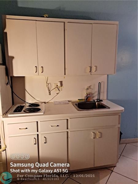 255 West 24th Street, Unit 105 Miami Beach, FL 33140 - Photo 26 of 47 a close view of a sink a faucet and a cabinet in a kitchen