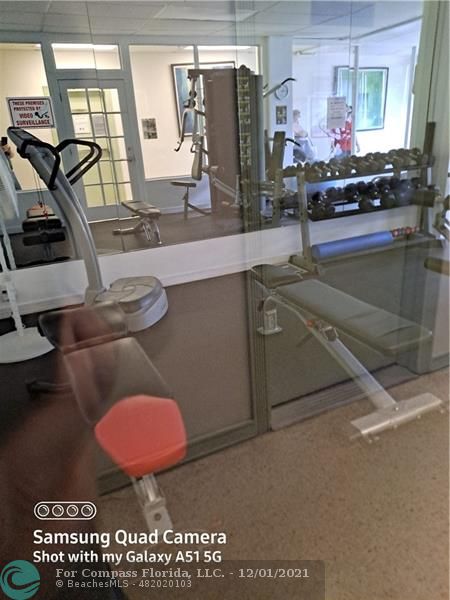 255 West 24th Street, Unit 105 Miami Beach, FL 33140 - Photo 28 of 47 a kitchen with a sink a stove and a wooden cabinets