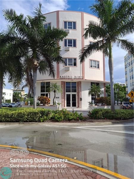 255 West 24th Street, Unit 105 Miami Beach, FL 33140 - Photo 32 of 47 a front view of a house with a yard and palm tree
