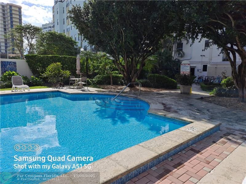 255 West 24th Street, Unit 105 Miami Beach, FL 33140 - Photo 37 of 47 a view of a swimming pool with a patio