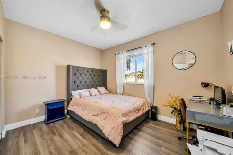 a living room with furniture a flat screen tv and a window