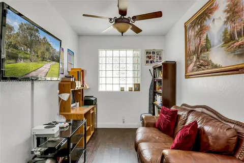 a front view of a house with a garden and palm trees