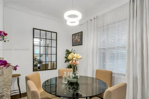 a living room with furniture kitchen view and a wooden floor