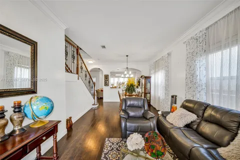 a hallway with a white stove top oven and a dishwasher with wooden floor