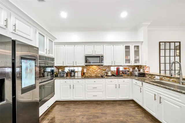 a spacious bedroom with a bed and wooden floor