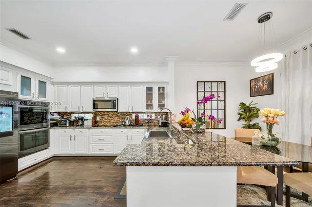 a bathroom with a tub sink double vanity and window