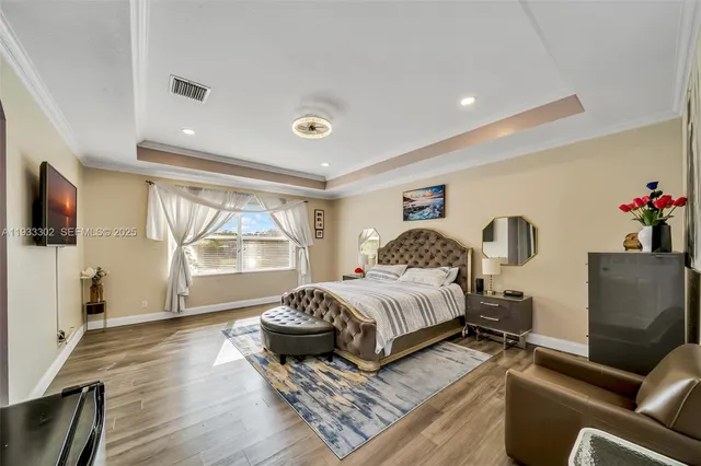 a living room with furniture a flat screen tv and a window