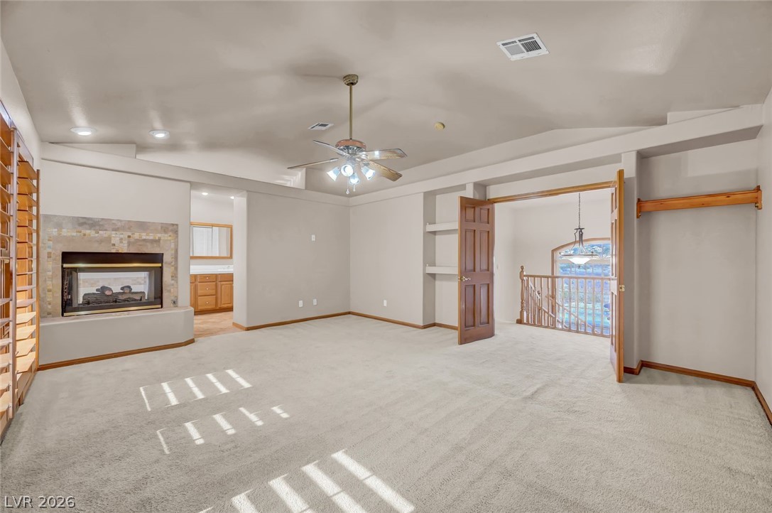640 North Racetrack Road Henderson, NV 89015 - Photo 43 of 65 A spacious secondary living area features a fireplace and staircase access, offering versatile living options.