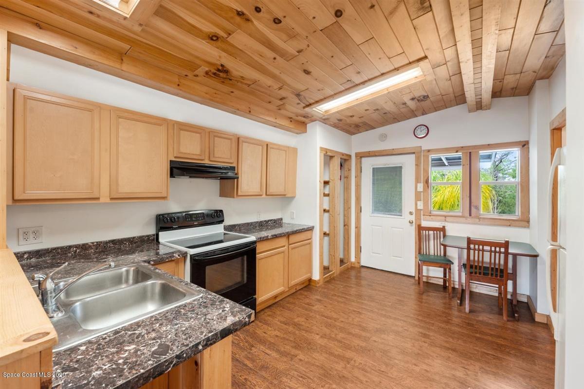 3600 Leghorn Road Grant Valkaria, FL 32950 - Photo 21 of 33 a kitchen with stainless steel appliances granite countertop a sink dishwasher stove refrigerator and cabinets